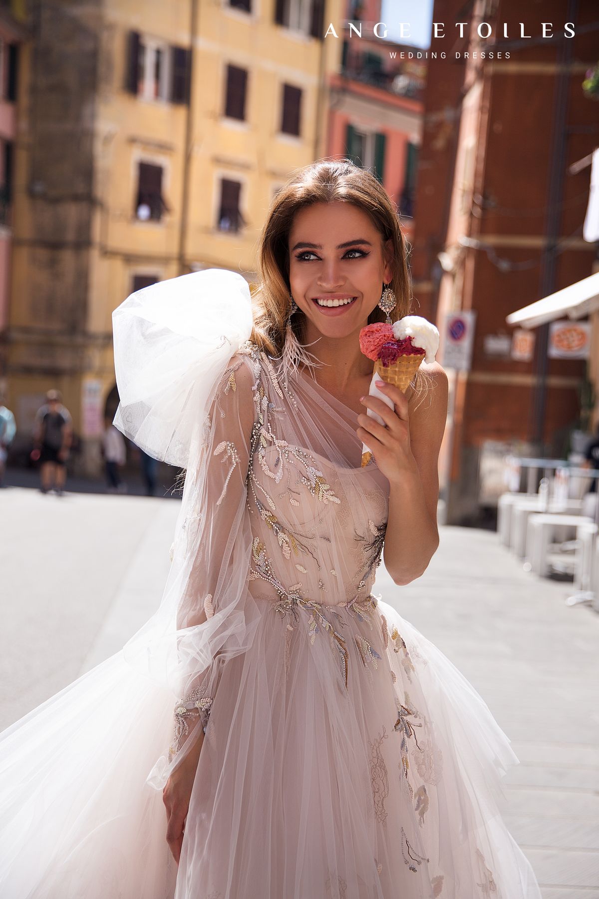 Rara Avis fluffy light train wedding dress Gretta with a left shoulder decorated with a detachable bow at Dell'Amore Bridal, NZ. 3