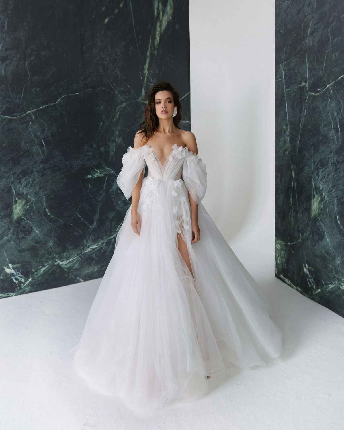 A-line silhouette wedding dress Melissa with the split on the skirt and off-shoulder sleeves by Rara Avis at Dell'Amore Bridal, Auckland. 10