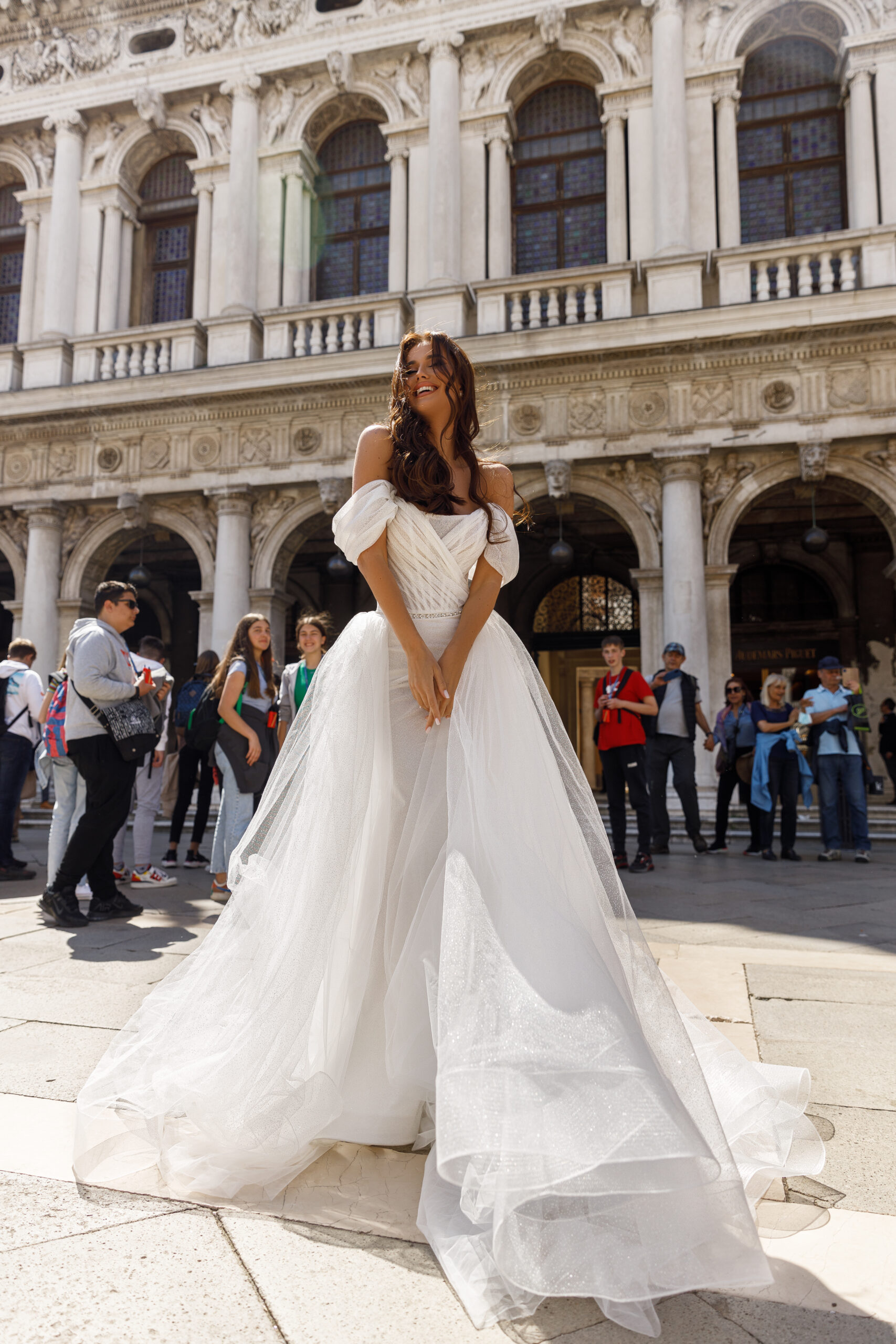 Luxurious sparkling minimalist wedding dress Athena with off-shoulder sleeves, removable skirt and beaded belt by Oksana Mukha designer, nz 1