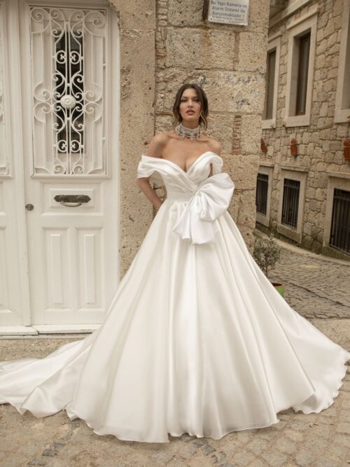 Satin white wedding gown Stella with a bow, off-shoulder sleeves and a-line skirt by Oksana Mukha designer 1