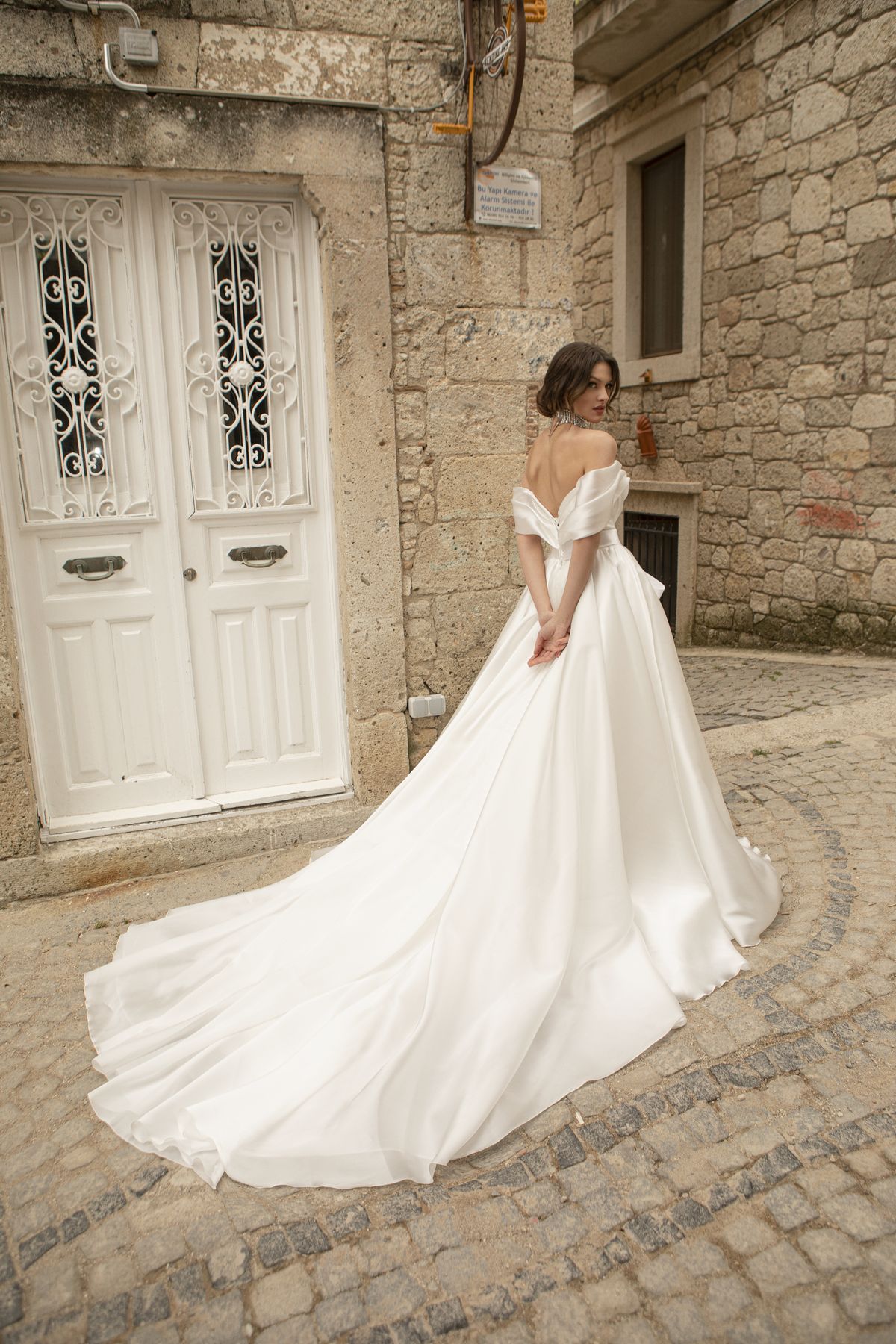 Satin white wedding gown Stella with a bow, off-shoulder sleeves and a-line skirt by Oksana Mukha designer 2