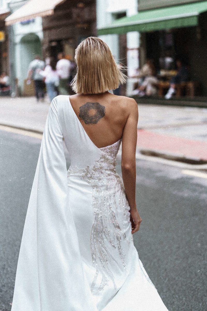 Fitted wedding gown Kasama with one shoulder and the skirt split by Rara Avis at Dell'Amore Bridal, Auckland. 2