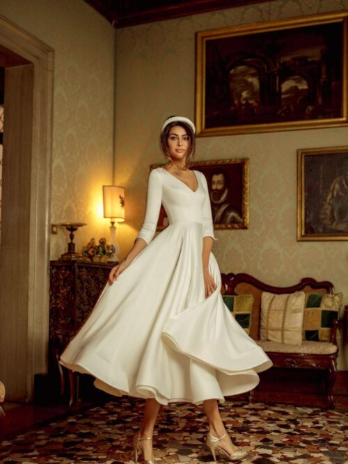 Simple white midi wedding dress Kriss with 3/4 sleeves and V-neckline by Rara Avis at Dell'Amore Bridal, Auckland, NZ. 3