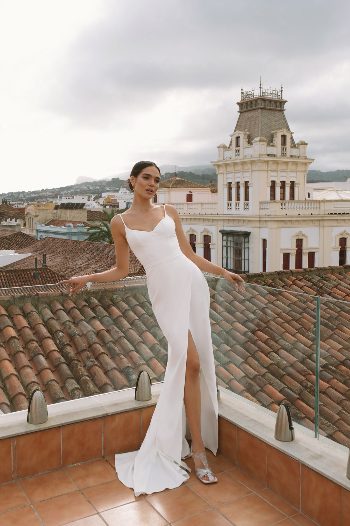 Simple fitted wedding dress Vidana with removable cape decorated with large 3-d flowers at Dell'Amore Bridal, NZ.2