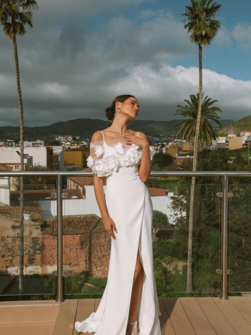 Simple fitted wedding dress Vidana with removable cape decorated with large 3-d flowers at Dell'Amore Bridal, NZ.1