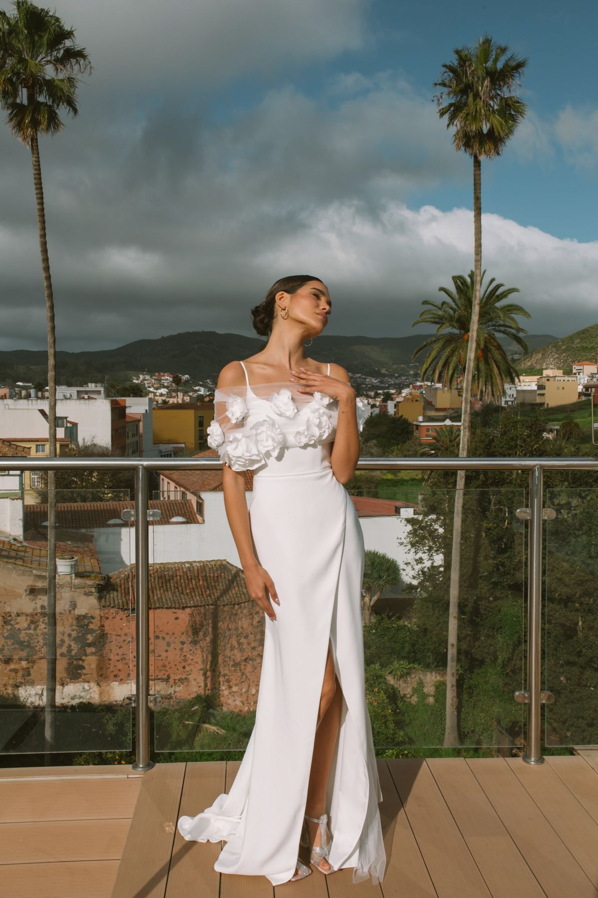 Simple fitted wedding dress Vidana with removable cape decorated with large 3-d flowers at Dell'Amore Bridal, NZ.1