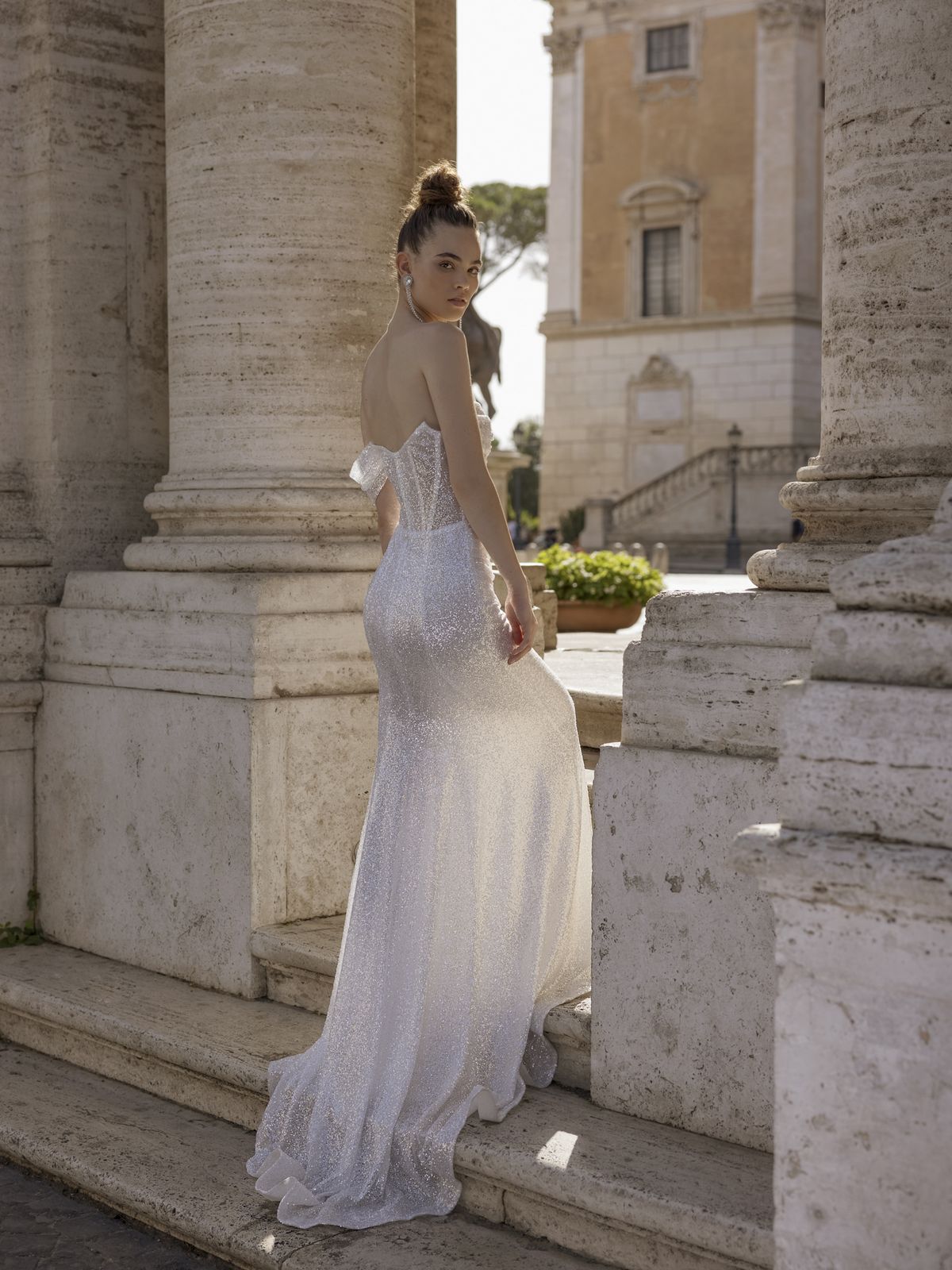 Fitted sparkling wedding dress Gracia with a wide draped shoulder strap and a detachable narrow sleeve by Rara Avis at Dell'Amore Bridal, Auckland. 7