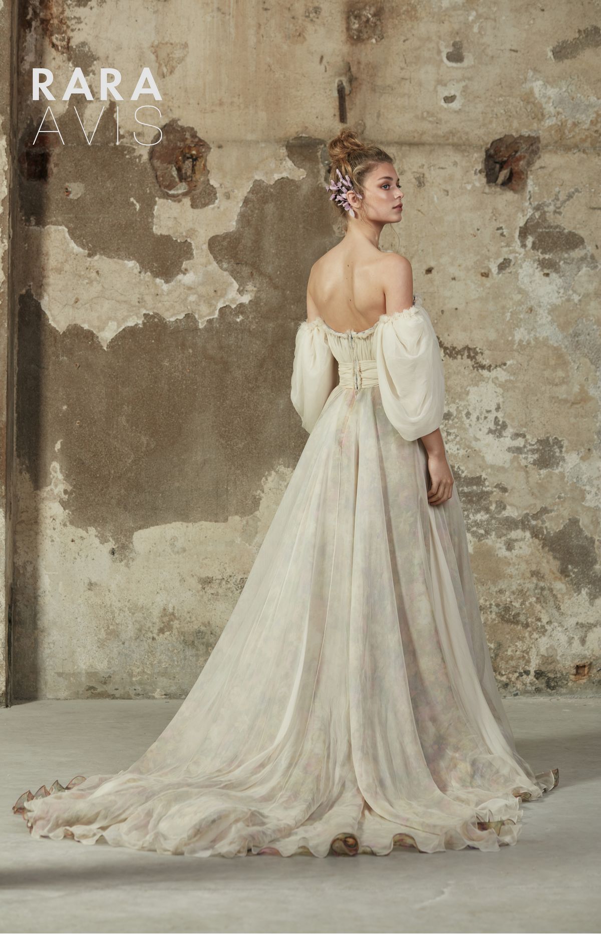 Romantic cream colour wedding gown Hilori by Rara Avis with purple flower decorations and long train.4